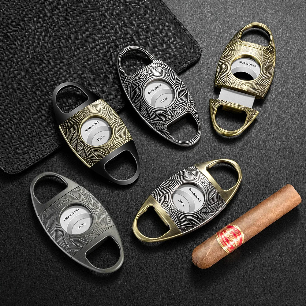 Collection of metallic cigar cutters on a dark surface with a cigar.