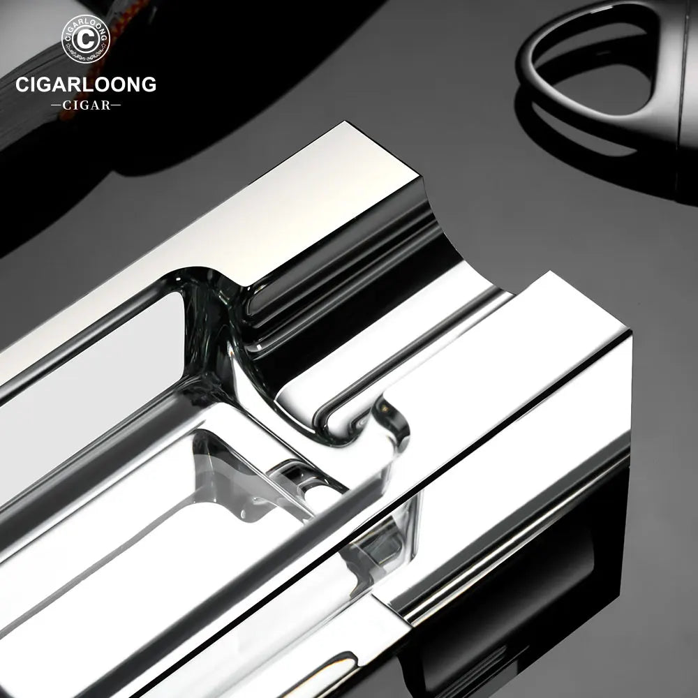 Metallic cigar cutter on a dark surface with 'Cigarloong' branding.