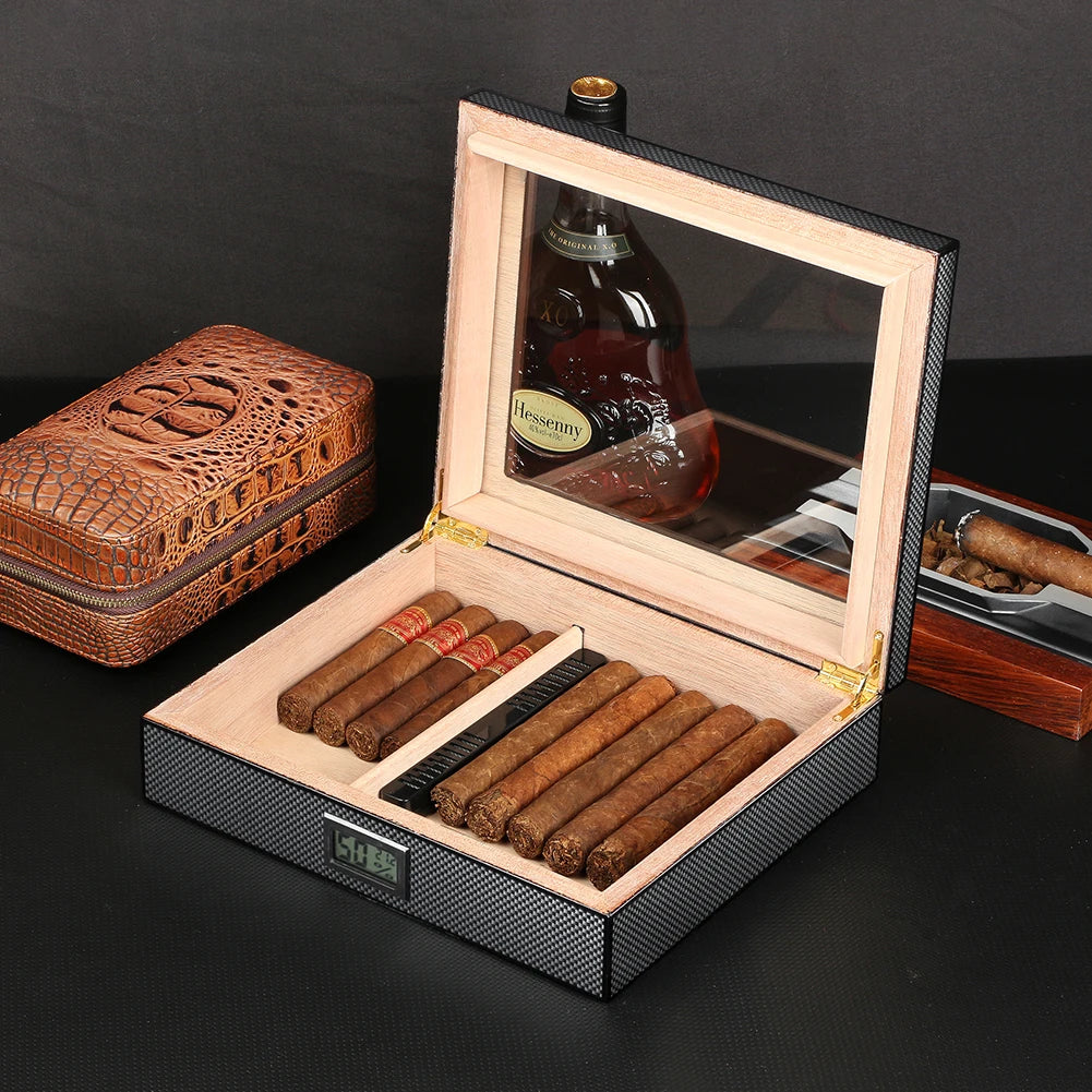 Cigar humidor with cigars and a bottle of liquor on a dark surface