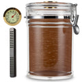 Glass jar humidor with cedar lined interior, metal clasp, and small hygrometer on a white background