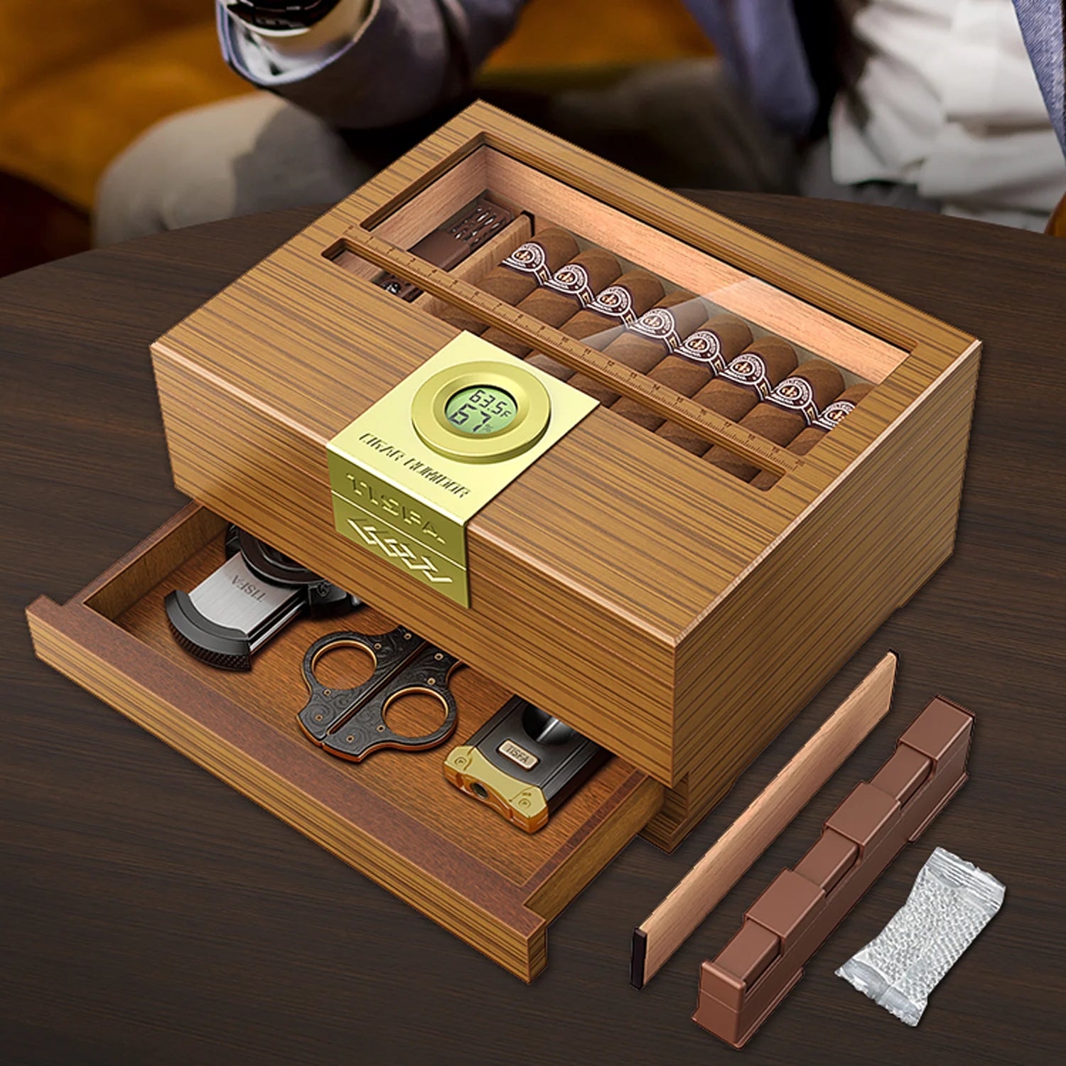Wooden cigar humidor with open drawer displaying cigars and accessories 
