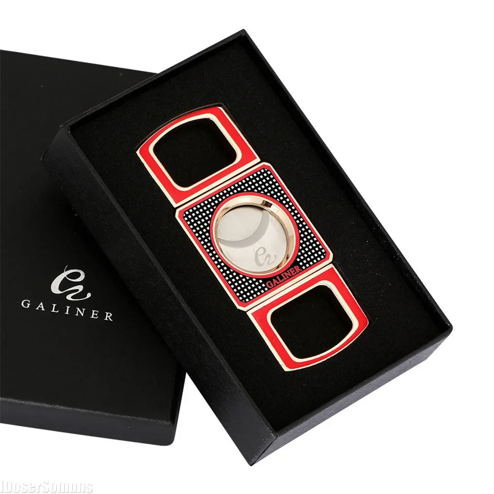 Red and gold pocket cigar cutter with black polka dot pattern on a black box.