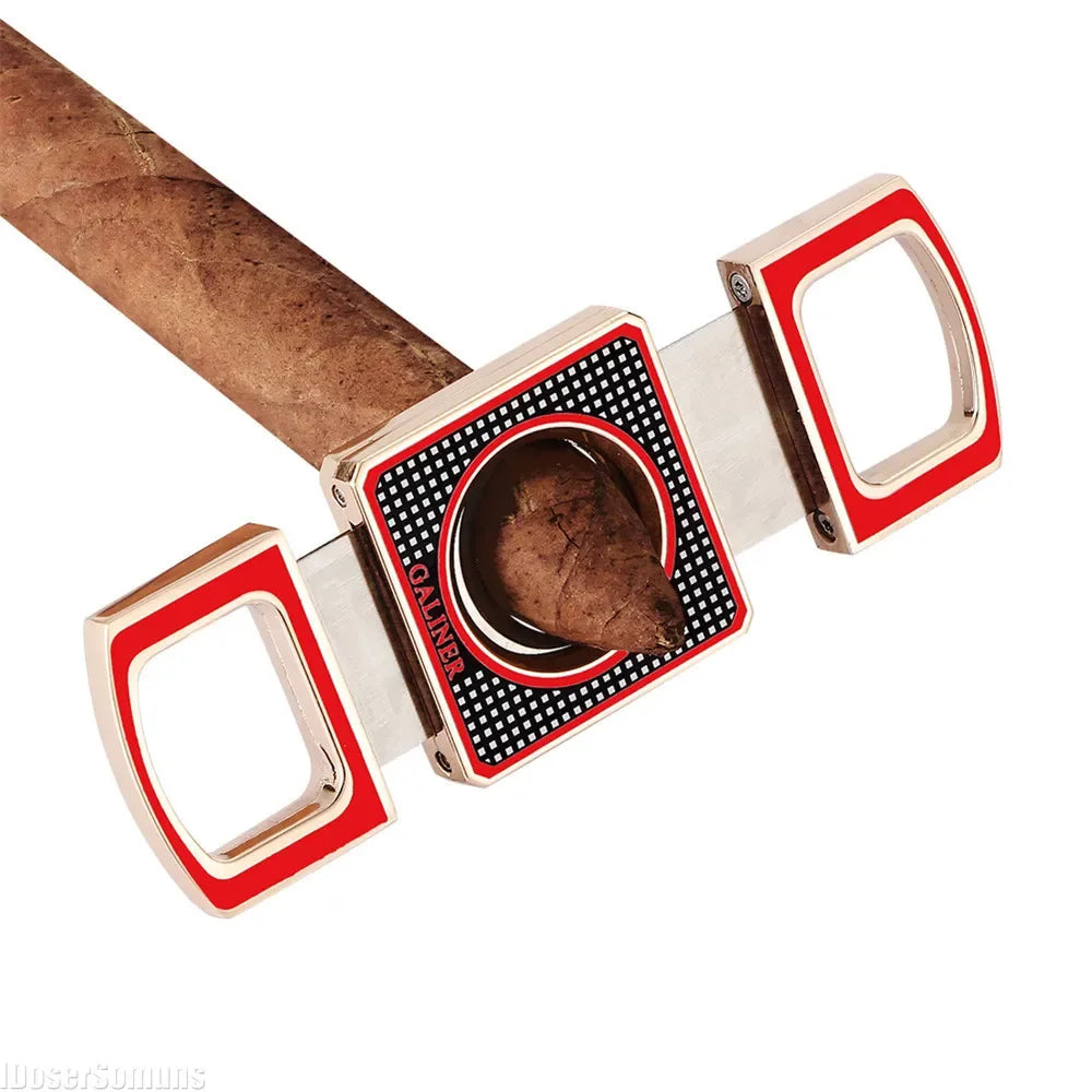 Cigar cutter with red and gold accents on a white background