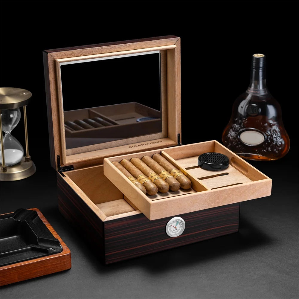 Open cigar humidor with cigars, a bottle of whiskey on a dark background